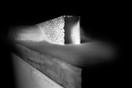 Illuminated plaster model of the Windhouse intervention showing the transition from a solid surface to an eroded, perforated concrete shell