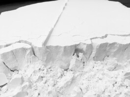 non-body-non-space, 2018. Close-up of the flour installation showing a fractured edge, cracked surface and loose granular material.
