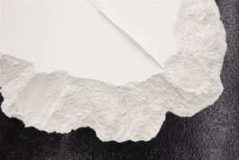 non-body-non-space, 2018. Detail of the flour installation showing the transition between a smooth cracked surface, rough granular edges and the dark gallery floor.