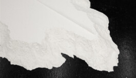 non-body-non-space, 2018. Detail of the flour installation showing the transition between a smooth cracked surface, rough granular material and the dark gallery floor.