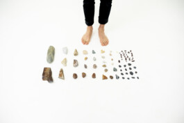 Video still from One Stone, 2022, by Jurgis Gečys, showing stones collected from different locations before being ground, mixed and compressed into a single stone.