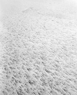 High-key analog black-and-white photograph showing the detailed surface of wind-shaped sand on the Curonian Spit.