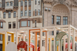 Detail of Dome Next Door, 2024, showing the contemporary timber structure and colourful architectural elements in dialogue with the historic façades of the UNESCO-listed Historic Centre of Riga, Latvia.