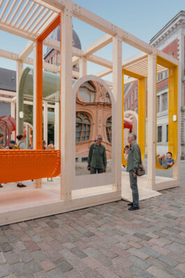 Dome Next Door, 2024, urban art installation in Riga Old Town, Latvia, showing visitors interacting with mirrored surfaces, suspended seating and the exposed timber structure.