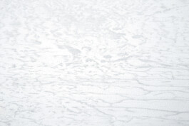 Detail view of The Inceptive Ground, Map, 2020 by Jurgis Gečys, showing thousands of minute blue-grey ink marks forming dense, fragmented layers and complex geological textures across the white surface.