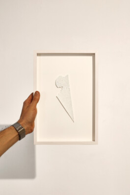 Jurgis Gečys holds the framed ink drawing Cognition, Backbord, composed of fine points and converging lines.
